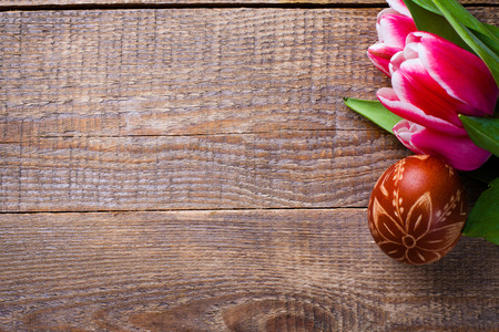 Easter egg and tulips on wooden background.の写真素材