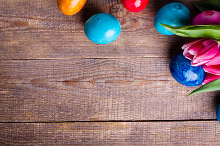 Easter egg and tulips on wooden background.の写真素材
