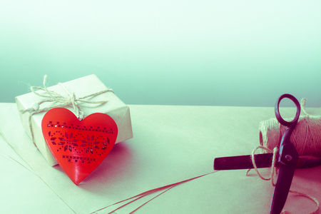 Valentines day gift wrapping with boxes and scissors over paper or wooden background.の写真素材