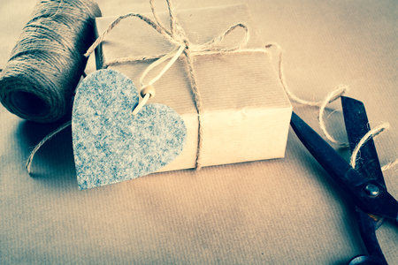 Valentines day gift wrapping with boxes and scissors over paper or wooden background.の写真素材