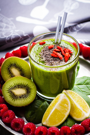 Green smoothies on a plate with baby spinach and raspberries.の写真素材