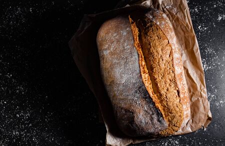 Fresh bread on a black background with copy space.の写真素材