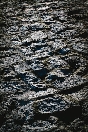 Pavement of large stones with cement or concrete background and texture.