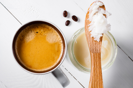 Bulletproof coffee, it's a coffee blended with butter or coconut oil. Wiev from above on coffee and coconut. Part of ketogenic diet, better choice before trainning.の写真素材