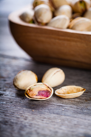 Pistachios in wooden bowl.の写真素材