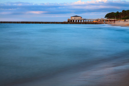 Blurry water of  long exposure time, the background with pier andrestaurant. Baltic Sea, Ustronie Morskie, Poland.の写真素材