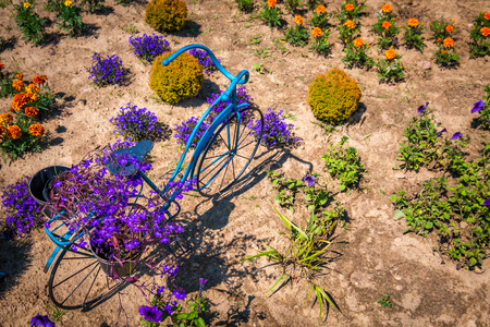Metal sculpture of bicycle as flowerbed in the garden.の写真素材