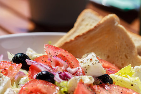 Fresh greek salad with grilled bread for healthy lunch.