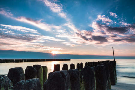 Wooden poles breaking sea water, long exposure. Poland, Baltic, Ustronie Morskie.の写真素材