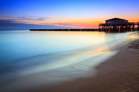 Wooden house restaurant on the water at pier, Baltic sea sunrise, Poland.の写真素材