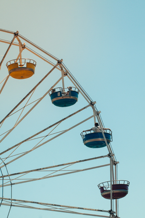 Vintage colorful ferris wheel over blue skyの写真素材