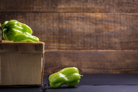 Green hot habanero peppers on cutting board.の写真素材