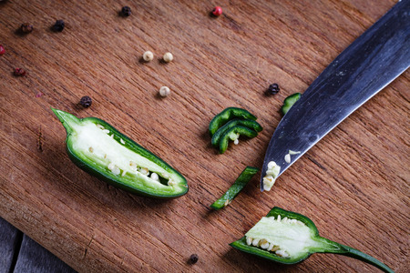 Green pepper on cutting board.の写真素材