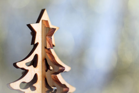 Wooden christmas tree on gold bokeh background. Decorative xmas card with copy space.