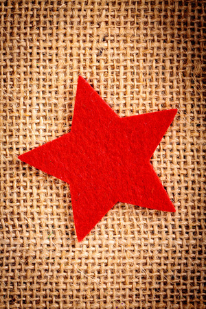 Felt christmas decorations on jute background.の写真素材