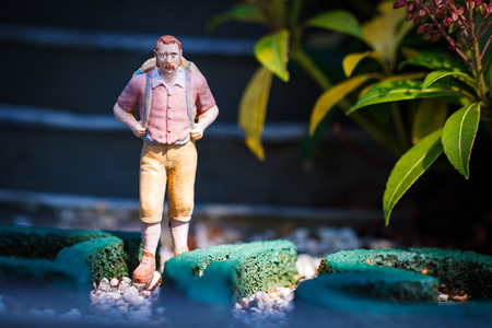 Small hiker figure walking with backback.の写真素材