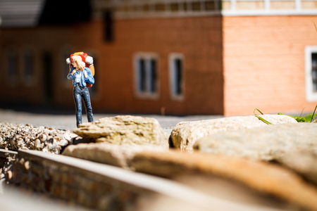 Small hiker figure walking with backback.の写真素材