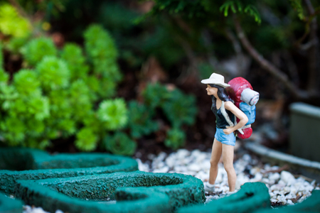 Small hiker figure walking with backback.の写真素材