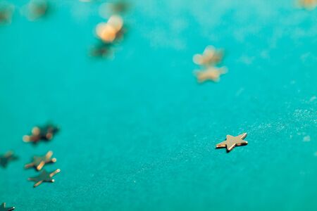 Little silver shiny star on blue background.の写真素材