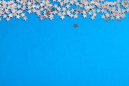 Frame of ters little silver stars on blue background.の写真素材