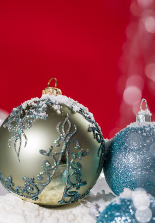 Christmas ball on snow and silver glitter backgroundの写真素材