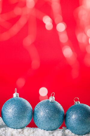 Christmas ball on snow and silver glitter backgroundの写真素材