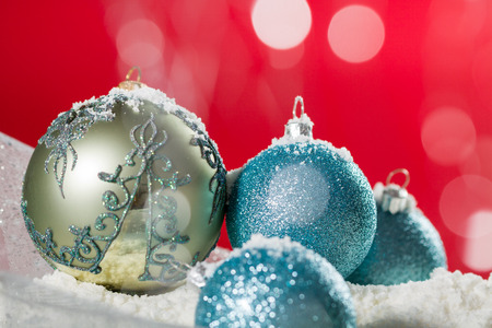 Christmas ball on snow and silver glitter backgroundの写真素材