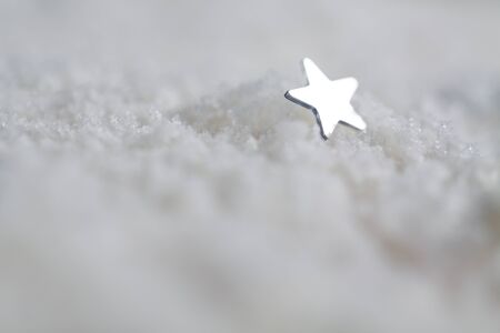 Small mirror star on white snow.の写真素材