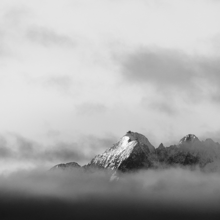 Ridges of Tatra mountains on clouds, black and white version, square frame.の写真素材