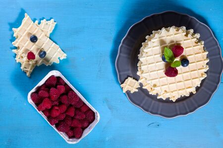 Belgian waffles with fresh blueberry and raspberry, decorated mint leaves.の写真素材