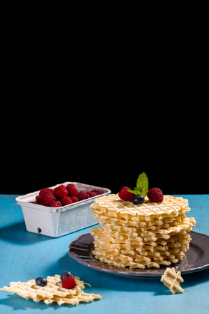 Belgian waffles with fresh blueberry and raspberry, decorated mint leaves.の写真素材
