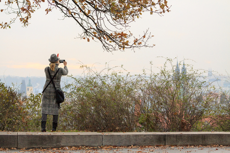 Young women photographs the panorama of Prague her smartphone.の写真素材