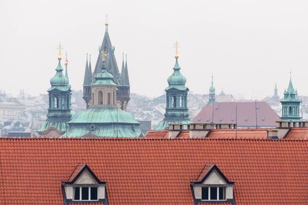 View on the red roofs and cathedral towers in Prague.の写真素材