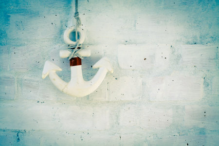 Wooden anchor on brick wall background.の写真素材