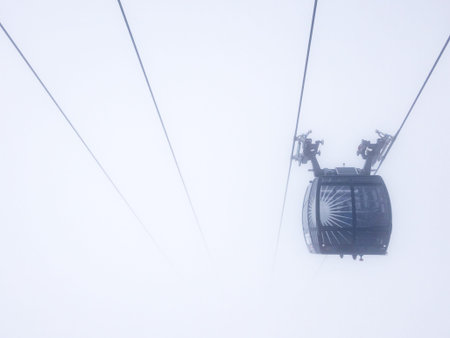 Ski lift carriage in dense fog.