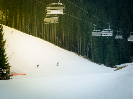 Skiers and snowboarders riding on a ski slope in Jasna Chopok in Slovakia ski resort.の写真素材