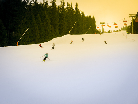 Skiers and snowboarders riding on a ski slope in Jasna Chopok in Slovakia ski resort.の写真素材