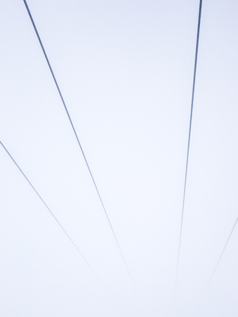 Symmetry lines of rope cableway ski lift at thick fog.の写真素材