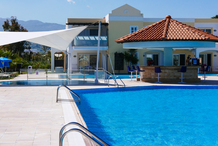 Hotel outdoor swimming pool with clear water and bar.の写真素材