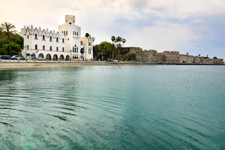 Building Kos Police Station and ancient ruins Neratzia Castle with turquoise water of Aegean Sea.の写真素材