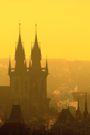Silhouette of roofs old town of Prague in morning orange light.の写真素材