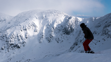 Alone skier ride outside the ski slope.の写真素材