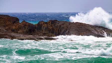 Big waves crashing against of the rocks.の写真素材