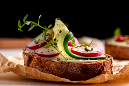 Sandwich with red radish, cucumber and fresh herbs and pepper.の写真素材