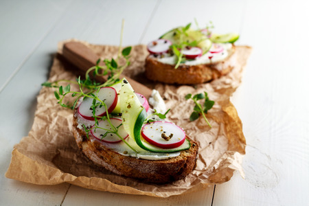 Sandwich with red radish, cucumber and fresh herbs and pepper.の写真素材