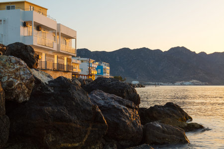 Beautiful sunrise landscape with sea, rock and mountains.