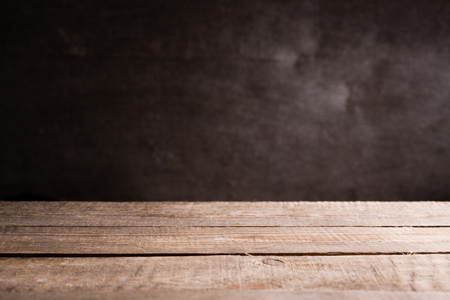 Gray old wall background and plank table.の写真素材