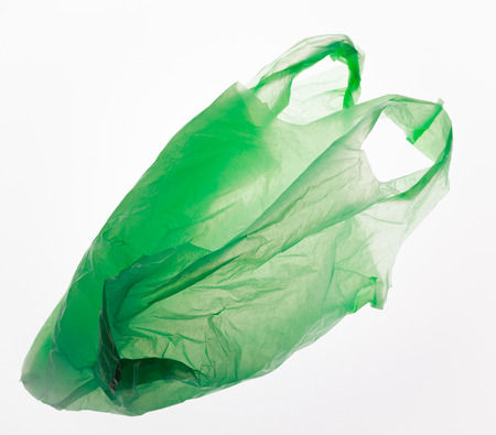 Green plastic bag isolated on white.