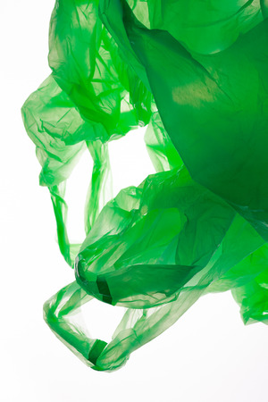 Crumpled green plastic bags isolated on white.の写真素材