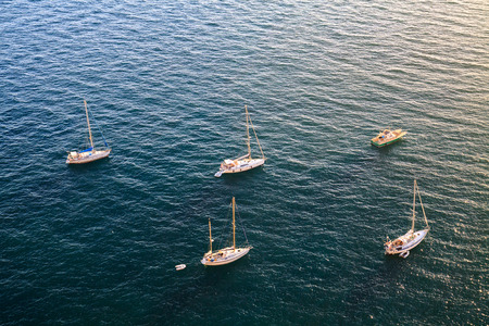 Few yachts are standing on the anchor, aerial view of sea surface.の写真素材